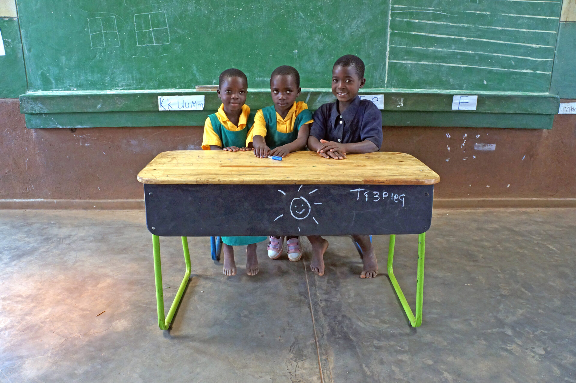 Photo of children sitting at prototype UNICEF classroom furniture