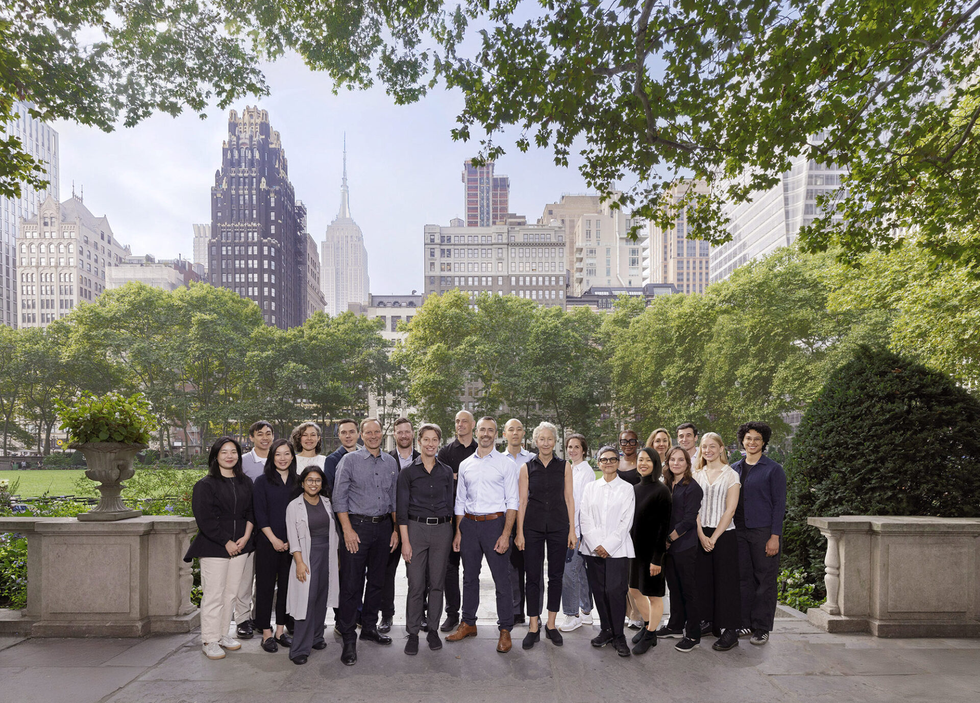 Photo of MBB Architects team standing together in Bryant Park, New York City